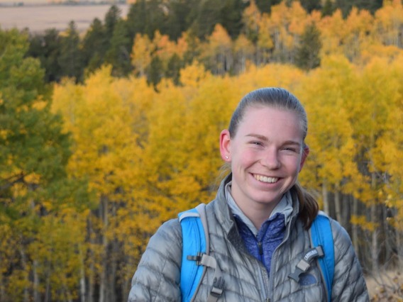Hannah Haugen with a background of autumn trees.